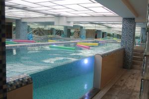 a large swimming pool with colorful lanes in a building at The Corporate Hotel in Ulaanbaatar