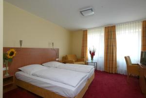 Postel nebo postele na pokoji v ubytování Hotel Mehl