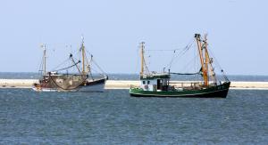 two boats are sitting in the water at BORKUMUNTERKUNFT - WOH2 - IM HERZEN DER INSEL in Borkum +7 photos