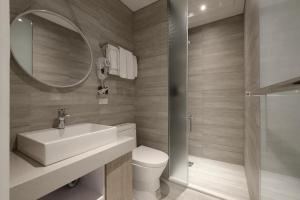 a bathroom with a sink and a toilet and a mirror at Taichung Amour Hotel in Taichung +52 photos