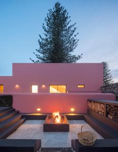 a fire pit in the backyard of a house at Pink House Azores in Ponta Delgada