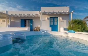 a swimming pool in front of a villa at Eiriana Luxury Suites in Plaka Milou