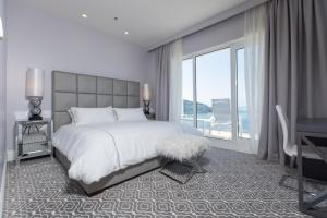 Ein Bett oder Betten in einem Zimmer der Unterkunft Royal Palm Hotel
