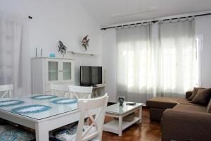 a living room with a table and a couch at Villa Corona Roses in Puerto del Carmen