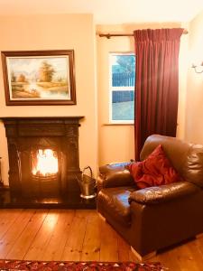 a living room with a couch and a fireplace at The-Gables in Donegal