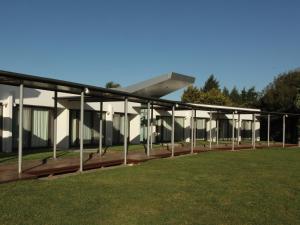 a large white building with a roof on a field at Hotel Camberland in Pilar +28 photos