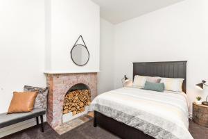 a bedroom with a bed and a fireplace at Central Bendigo Cottage, walk to everywhere!! in Bendigo