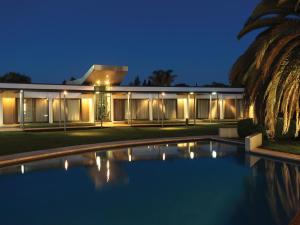 a house with a swimming pool in front of it at Hotel Camberland in Pilar +28 photos