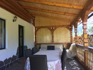 a room with a table and chairs on a balcony at Casa Nova in Vişeu de Sus