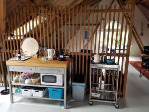 a kitchen with a counter with a microwave on it at Hofstede Prinsland in Kortgene
