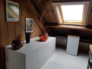 a kitchen with a white cabinet with vases on it at Hofstede Prinsland in Kortgene