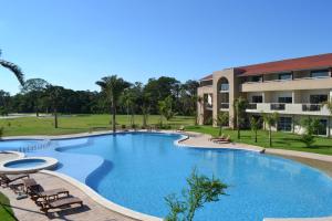 a large swimming pool in front of a building at Sun Hotel in Santa Cruz de la Sierra