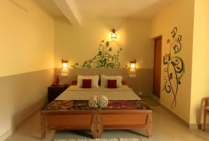 a bedroom with a large bed in a room at Thekkady Homestay in Thekkady