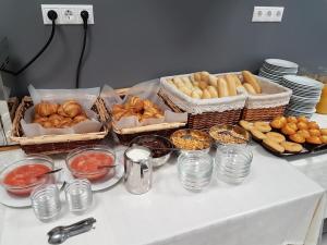 a table with many baskets of bread and pastries at Hostal El Altet in El Alted