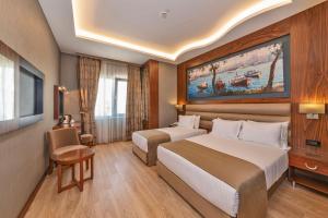 a hotel room with two beds and a tv at Piya Sport Hotel in Istanbul +90 photos