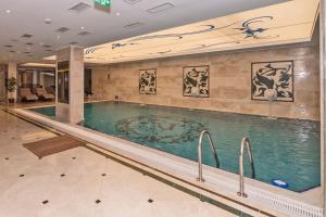 a large swimming pool in a hotel lobby at Piya Sport Hotel in Istanbul