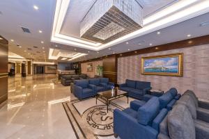 a lobby with blue couches and a table at Piya Sport Hotel in Istanbul