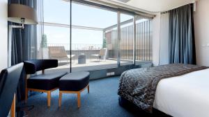 a hotel room with a bed and a large window at Hotel Royal Passeig de Gracia in Barcelona