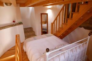 a bedroom with a bed and a staircase at Olá Belém! Cozy Windmill, Stunning views to Lisboa in Caparica