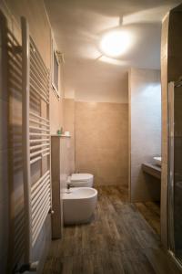 a bathroom with a white toilet and a sink at Agape in Taranto