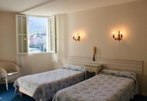 A bed or beds in a room at Hôtel Sainte Marie