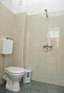 a bathroom with a toilet and a shower at Family Hotel Blazhi in Sandanski