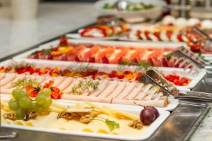 a buffet of different types of food on plates at PRIVILEGED LESNÁ - with Garden Terrace in Tatranská Lomnica