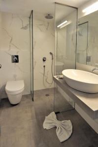 a bathroom with a sink and a toilet at Pennystella Apartments in Agia Pelagia