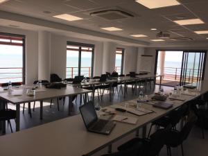 a large room with tables and chairs with a laptop at Hotel Les Dunes in La Tranche-sur-Mer +117 photos