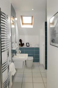 a bathroom with a toilet and a sink at Corner House Bed & Breakfast in West Runton
