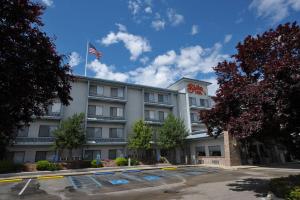 a hotel with an american flag on top of it at Shilo Inn Suites Hotel - Nampa Suites in Nampa
