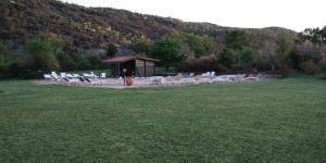 un gruppo di sedie e un gazebo in un campo di Borgo Cerbaiola a Montecastelli