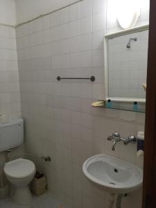 a bathroom with a toilet and a sink and a mirror at Murat Hotel in Demre +36 photos