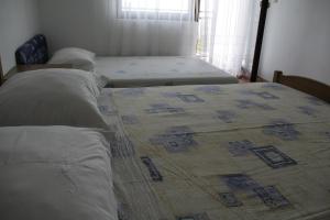 Postel nebo postele na pokoji v ubytování Apartmani Huljev