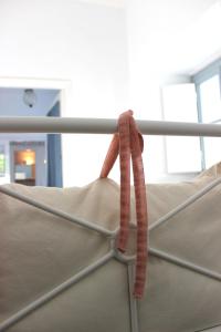 a close up of a bed with a pink ribbon at Studio Annezo in Hydra