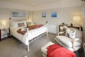 a bedroom with two beds and a couch and a chair at Corner House Bed & Breakfast in West Runton