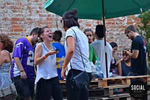 a group of people standing under an umbrella at Social Hostel Café e Bar in Curitiba