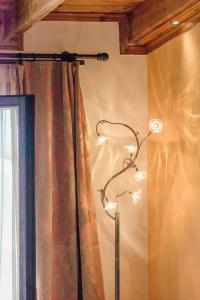 a lamp in a room next to a curtain at Elois Suites in Rethymno Town +78 photos