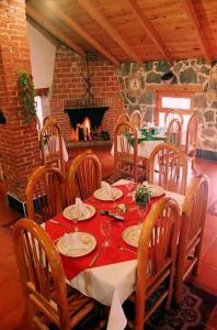 a dining room with a table and a fireplace at Hotel Bella Vista in Huasca de Ocampo