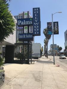 a sign for a store on a city street at Hollywood Palms Inns & Suites in Los Angeles