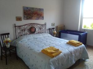 1 dormitorio con 1 cama con 2 toallas en B&B Notte Al Museo, en Bitti