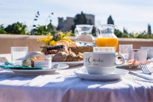 a table with food and a cup of coffee on it at Il Chiostro Appartamenti & Suites in Suvereto