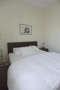 A bed or beds in a room at Christini Apartment