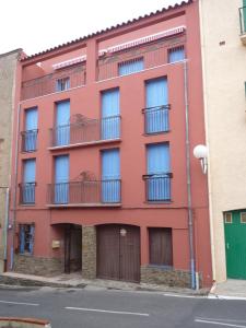 an orange building with balconies and a street at Appartement Centre Collioure Patio Wifi Clim in Collioure