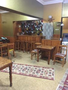 a dining room with wooden tables and chairs at Murat Hotel in Demre