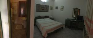 a bedroom with a bed and a sink and a mirror at Sant Efisio in Lotzorai