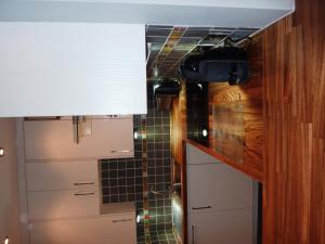 a kitchen with a counter and a tile wall at Hewlett Apartments in Cheltenham