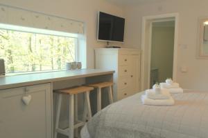 a bedroom with a bed and a kitchen with a counter at Ashford house 'The Snug' private hot tub in Fylingthorpe
