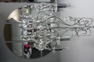 a chandelier hanging in front of a mirror at Hewlett Apartments in Cheltenham