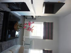 a living room with a couch and a window at Hewlett Apartments in Cheltenham